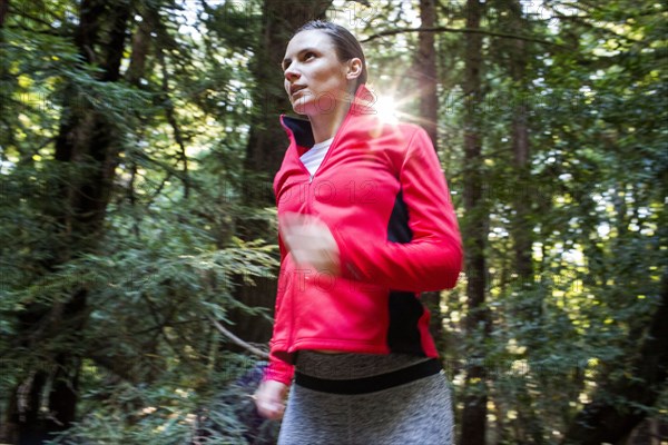 Woman running in forest