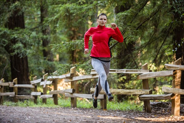 Woman running on forest path