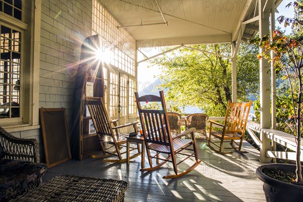 Reflection of sun on porch with rocking chairs