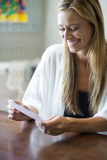 Caucasian woman reading invitation