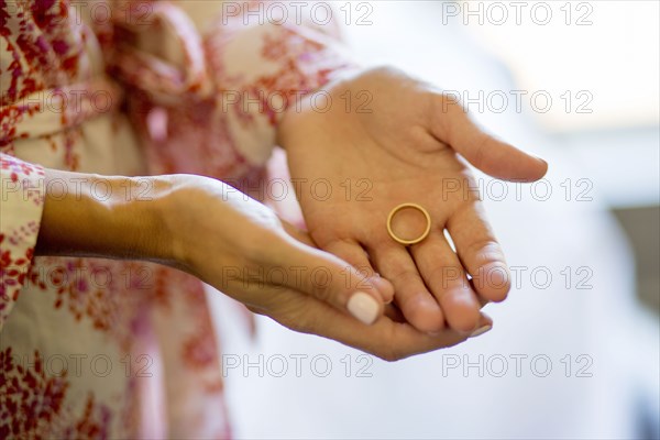 Caucasian woman holding wedding ring