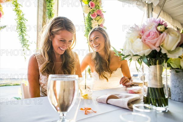 Caucasian brides sitting at table