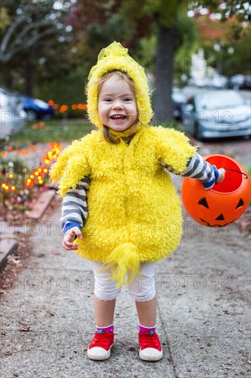 Smiling Caucasian girl wearing chicken costume on Halloween