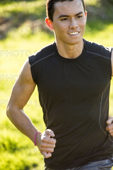 Smiling Mixed Race man running