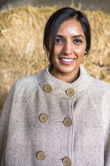 Portrait of smiling Indian woman wearing poncho