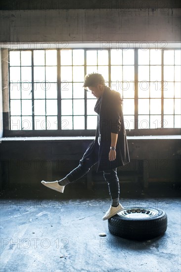 Androgynous Asian man standing on wheel