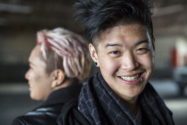 Androgynous Asian man and woman back to back