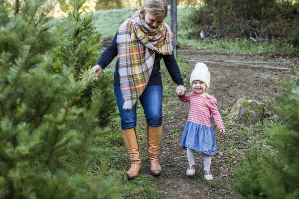 Caucasian mother and daughter walking on path