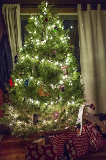 Gifts under illuminated Christmas tree