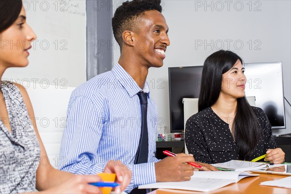 People smiling in business meeting