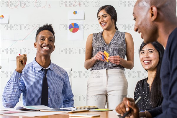 People laughing in business meeting