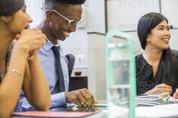 Smiling people talking in meeting