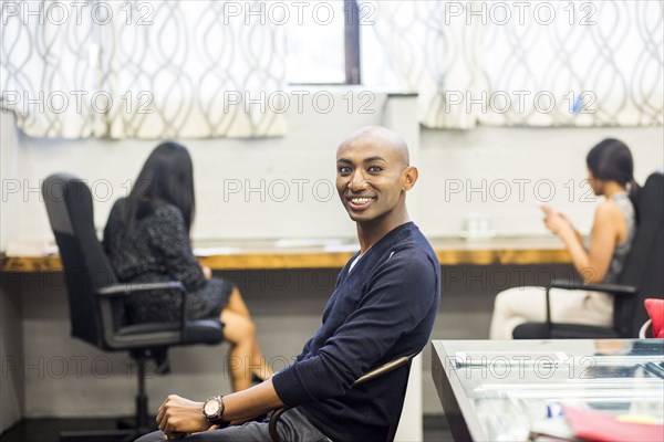 Portrait of smiling African American man sitting in office