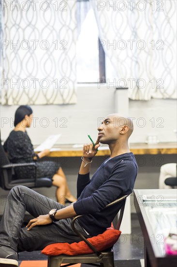 Portrait of pensive African American man sitting in office