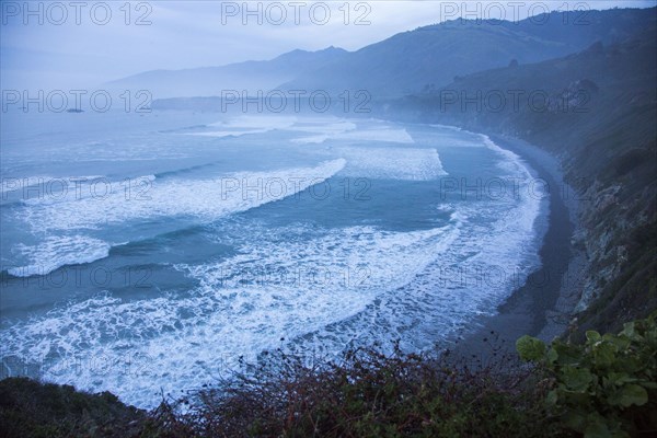 Scenic view of ocean beach and cliffs