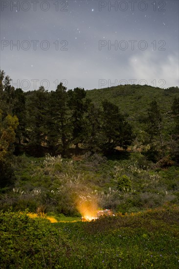 Campfire on hill at night