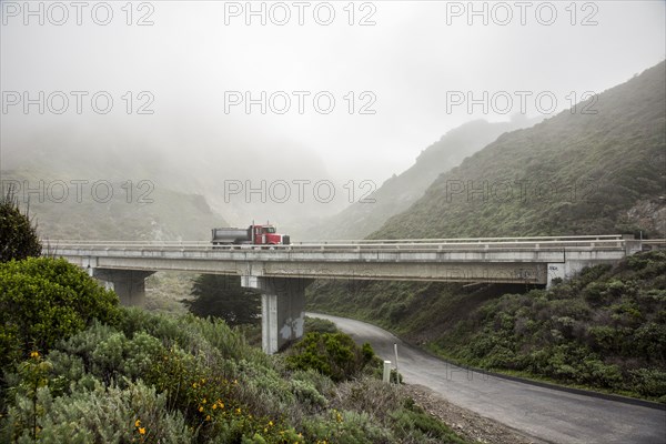 Truck driving on overpass in hills