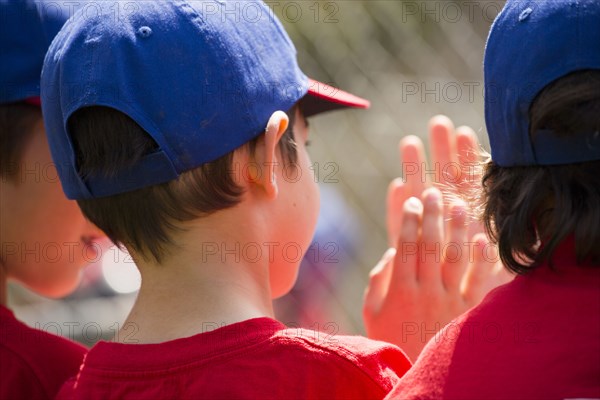 Mixed Race boys playing baseball high-fiving