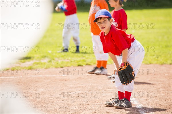 Mixed Race boy playing baseball