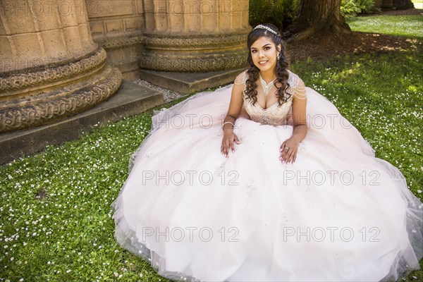 Portrait of smiling Hispanic girl wearing gown