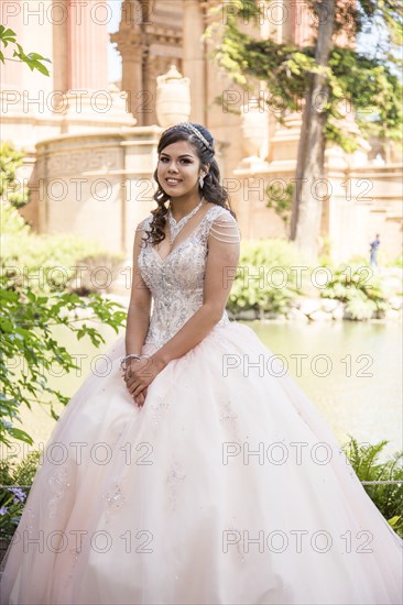 Portrait of smiling Hispanic girl wearing gown