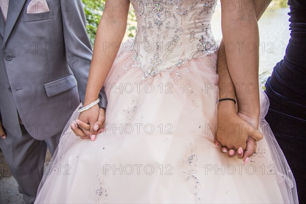 Hispanic boy and girls holding hands