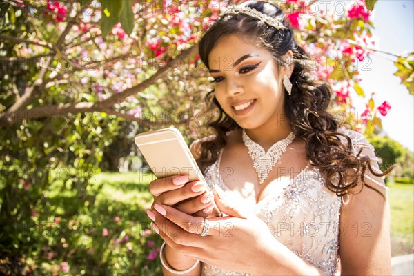 Hispanic girl texting on cell phone