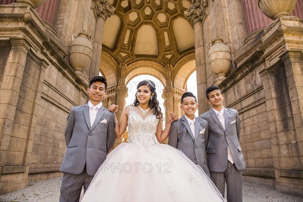 Hispanic girl posing with boys