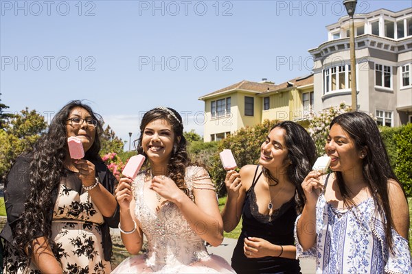 Hispanic girls eating popsicles