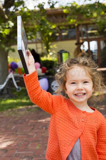 Portrait of Caucasian girl holding DVD movie