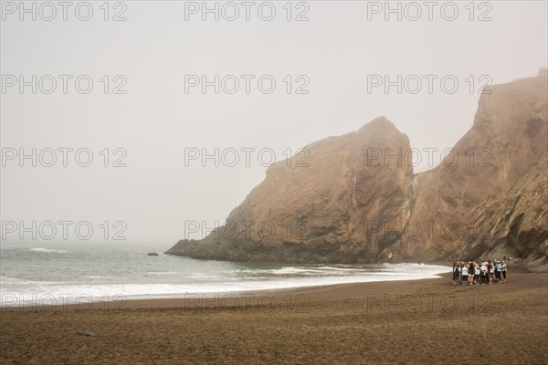 Distant crowd of people standing on beach