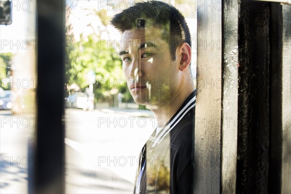 Serious Chinese man behind window