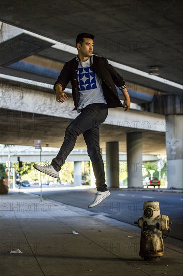 Chinese man jumping over hydrant