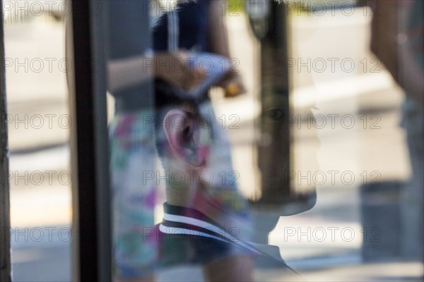 Serious Chinese man behind window