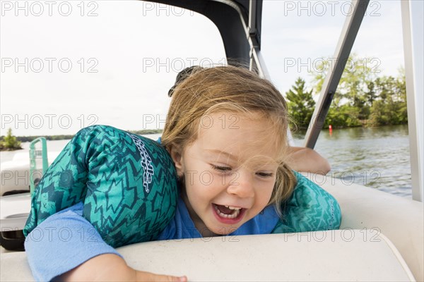 Smiling Caucasian girl on boat