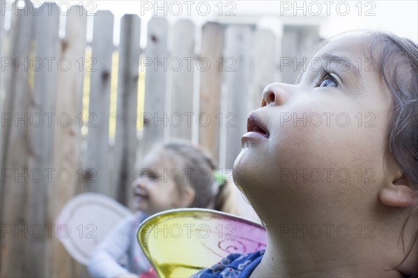 Curious girls wearing fairy wings outdoors