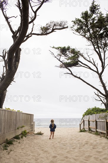 Caucasian girl walking on beach