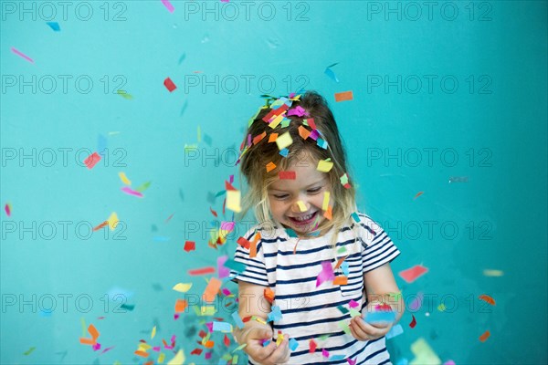 Colorful confetti falling on Caucasian girl