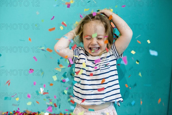 Colorful confetti falling on Caucasian girl