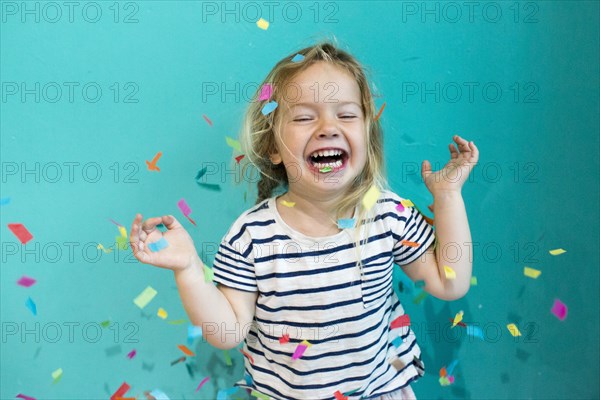 Colorful confetti falling on Caucasian girl