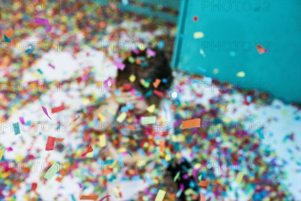 Colorful confetti falling on Caucasian girl