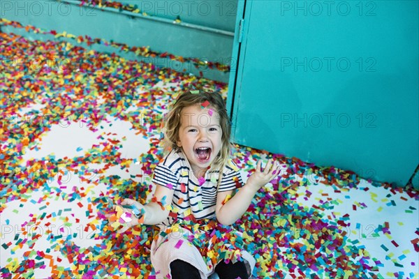 Colorful confetti falling on Caucasian girl