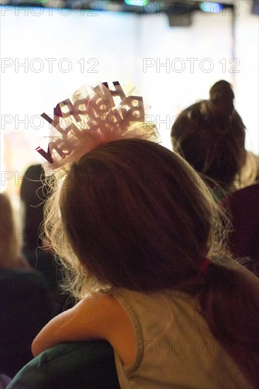 Rear view of Caucasian girl wearing birthday headband