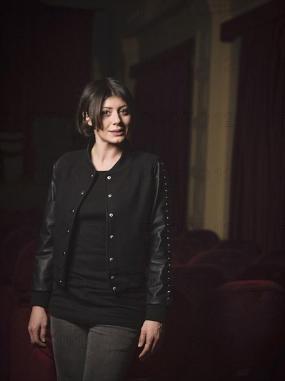 Caucasian woman standing in movie theater