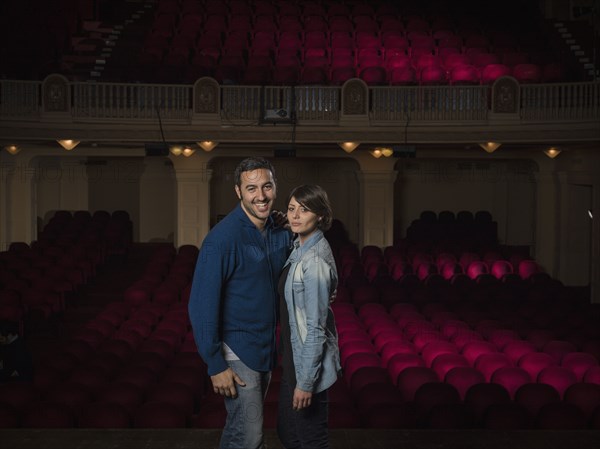 Caucasian couple standing in movie theater