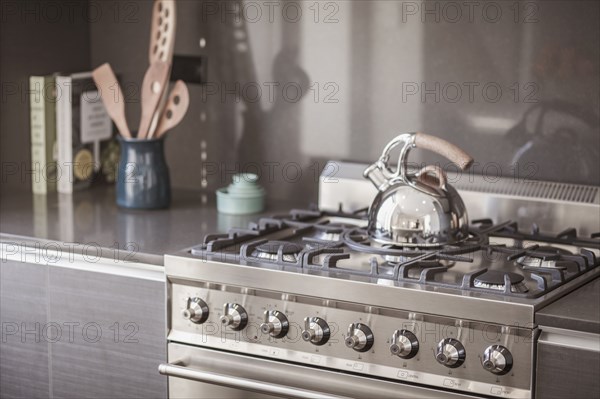 Kettle on stainless steel stove in modern kitchen