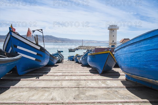 Blue boats docked on boat ramp