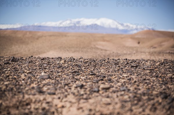 Surface level view of gravel field and remote desert