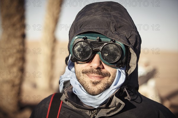 Caucasian traveler wearing goggles and gear