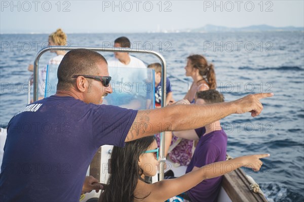 Family admiring ocean view from boat